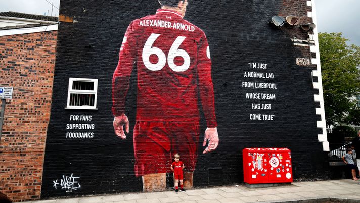 LIVERPOOL, ENGLAND - JULY 26: A young Liverpool FC fan poses for a photograph in front of Liverpool player Trent Alexander-Arnold's mural on July 26, 2020 in Liverpool, England. (Photo by Clive Brunskill/Getty Images) 