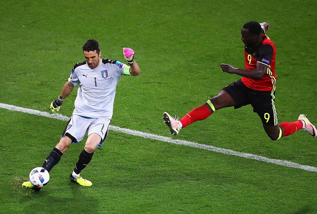  LYON, FRANCE - JUNE 13: Gianluigi Buffon of Italy clears the ball while Romelu Lukaku of Belgium jumps for the ball during the UEFA EURO 2016 Group E match between Belgium and Italy at Stade des Lumieres on June 13, 2016 in Lyon, France.  (Photo by Clive Brunskill/Getty Images) 