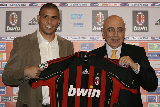 MILAN, ITALY - FEBRUARY 02: Brazilian striker Ronaldo poses with AC Milan Vice President Adriano Galliani and his AC Milan jersey on February 2, 2007 in Milan, Italy. After two weeks of negotiations between Real Madrid and AC Milan,  Ronaldo signed an 18-month contract,  for  7.5 million euros (9.7 million dollars). (Photo by Guiseppe Cacace/Getty Images) 