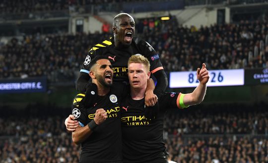 MADRID, SPAIN - FEBRUARY 26: Kevin De Bruyne of Manchester City celebrates with teammates Riyad Mahrez and Benjamin Mendy after scoring his team's second goal during the UEFA Champions League round of 16 first leg match between Real Madrid and Manchester City at Bernabeu on February 26, 2020 in Madrid, Spain. (Photo by David Ramos/Getty Images) MADRID, SPAIN - FEBRUARY 26: Kevin De Bruyne of Manchester City celebrates with teammates Riyad Mahrez and Benjamin Mendy after scoring his team's second goal during the UEFA Champions League round of 16 first leg match between Real Madrid and Manchester City at Bernabeu on February 26, 2020 in Madrid, Spain. (Photo by David Ramos/Getty Images)