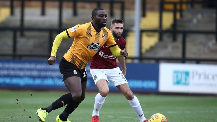 CAMBRIDGE, ENGLAND - JANUARY 19: Jabo Ibehre of Cambridge United moves forward with the ball away from Jordan Turnbull of Northampton Town during the Sky Bet League Two match between Cambridge United and Northampton Town at Abbey Stadium on January 19, 2019 in Cambridge, United Kingdom. (Photo by Pete Norton/Getty Images) CAMBRIDGE, ENGLAND - JANUARY 19: Jabo Ibehre of Cambridge United moves forward with the ball away from Jordan Turnbull of Northampton Town during the Sky Bet League Two match between Cambridge United and Northampton Town at Abbey Stadium on January 19, 2019 in Cambridge, United Kingdom. (Photo by Pete Norton/Getty Images)