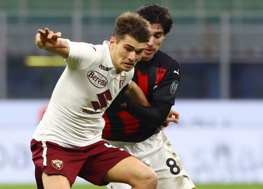  MILAN, ITALY - JANUARY 12: Jacopo Segre of Torino F.C. is challenged by Sandro Tonali of A.C. Milan during the Coppa Italia match between AC Milan and Torino FC at Stadio Giuseppe Meazza on January 12, 2021 in Milan, Italy. Sporting stadiums around Italy remain under strict restrictions due to the Coronavirus Pandemic as Government social distancing laws prohibit fans inside venues resulting in games being played behind closed doors. (Photo by Marco Luzzani/Getty Images) 