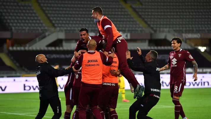 TURIN, ITALY - MAY 03: Mergim Vojvoda of Torino FC celebrates with team mates after scoring their side's first goal during the Serie A match between Torino FC and Parma Calcio at Stadio Olimpico di Torino on May 03, 2021 in Turin, Italy. Sporting stadiums around Italy remain under strict restrictions due to the Coronavirus Pandemic as Government social distancing laws prohibit fans inside venues resulting in games being played behind closed doors. (Photo by Valerio Pennicino/Getty Images)