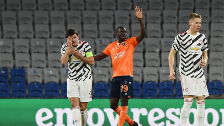ISTANBUL, TURKEY - NOVEMBER 04: Harry Maguire of Manchester United and Demba Ba of Istanbul Basaksehir react after a Collison during the UEFA Champions League Group H stage match between Istanbul Basaksehir and Manchester United at Basaksehir Fatih Terim Stadyumu on November 04, 2020 in Istanbul, Turkey. Sporting stadiums around Turkey remain under strict restrictions due to the Coronavirus Pandemic as Government social distancing laws prohibit fans inside venues resulting in games being played behind closed doors. (Photo by Burak Kara/Getty Images) ISTANBUL, TURKEY - NOVEMBER 04: Harry Maguire of Manchester United and Demba Ba of Istanbul Basaksehir react after a Collison during the UEFA Champions League Group H stage match between Istanbul Basaksehir and Manchester United at Basaksehir Fatih Terim Stadyumu on November 04, 2020 in Istanbul, Turkey. Sporting stadiums around Turkey remain under strict restrictions due to the Coronavirus Pandemic as Government social distancing laws prohibit fans inside venues resulting in games being played behind closed doors. (Photo by Burak Kara/Getty Images)