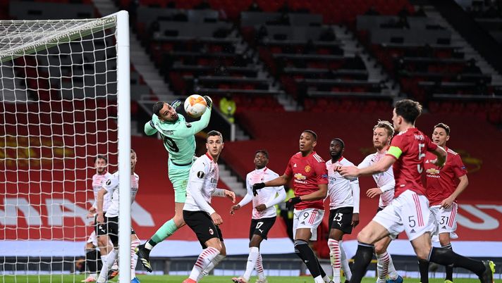 MANCHESTER, ENGLAND - MARCH 11: Gianluigi Donnarumma of A.C. Milan makes a save leading to a missed chance for Harry Maguire of Manchester United during the UEFA Europa League Round of 16 First Leg match between Manchester United and A.C. Milan at Old Trafford on March 11, 2021 in Manchester, England. Sporting stadiums around the UK remain under strict restrictions due to the Coronavirus Pandemic as Government social distancing laws prohibit fans inside venues resulting in games being played behind closed doors. (Photo by Laurence Griffiths/Getty Images) MANCHESTER, ENGLAND - MARCH 11: Gianluigi Donnarumma of A.C. Milan makes a save leading to a missed chance for Harry Maguire of Manchester United during the UEFA Europa League Round of 16 First Leg match between Manchester United and A.C. Milan at Old Trafford on March 11, 2021 in Manchester, England. Sporting stadiums around the UK remain under strict restrictions due to the Coronavirus Pandemic as Government social distancing laws prohibit fans inside venues resulting in games being played behind closed doors. (Photo by Laurence Griffiths/Getty Images)