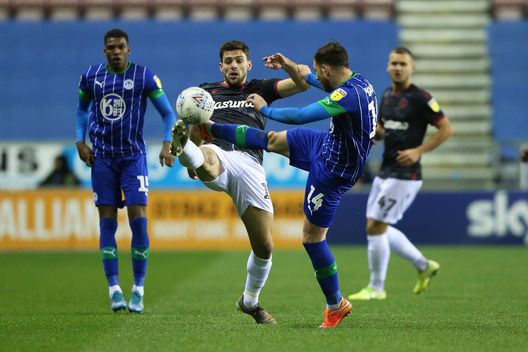 WIGAN, ENGLAND - NOVEMBER 30: Joe Garner of Wigan Athletic tackles Lucas Boye of Reading FC during the Sky Bet Championship match between Wigan Athletic and Reading at DW Stadium on November 30, 2019 in Wigan, England. (Photo by Charlotte Tattersall/Getty Images) WIGAN, ENGLAND - NOVEMBER 30: Joe Garner of Wigan Athletic tackles Lucas Boye of Reading FC during the Sky Bet Championship match between Wigan Athletic and Reading at DW Stadium on November 30, 2019 in Wigan, England. (Photo by Charlotte Tattersall/Getty Images)