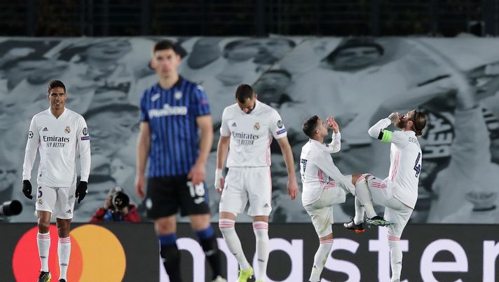 MADRID, SPAIN - MARCH 16: Sergio Ramos of Real Madrid celebrates with teammate Lucas Vazquez after scoring their team's second goal during the UEFA Champions League Round of 16 match between Real Madrid and Atalanta at Estadio Alfredo Di Stefano on March 16, 2021 in Madrid, Spain. Sporting stadiums around Spain remain under strict restrictions due to the Coronavirus Pandemic as Government social distancing laws prohibit fans inside venues resulting in games being played behind closed doors. (Photo by Gonzalo Arroyo Moreno/Getty Images) MADRID, SPAIN - MARCH 16: Sergio Ramos of Real Madrid celebrates with teammate Lucas Vazquez after scoring their team's second goal during the UEFA Champions League Round of 16 match between Real Madrid and Atalanta at Estadio Alfredo Di Stefano on March 16, 2021 in Madrid, Spain. Sporting stadiums around Spain remain under strict restrictions due to the Coronavirus Pandemic as Government social distancing laws prohibit fans inside venues resulting in games being played behind closed doors. (Photo by Gonzalo Arroyo Moreno/Getty Images)