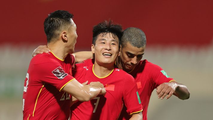SHARJAH, UNITED ARAB EMIRATES - OCTOBER 07: Lei Wu of China PR celebrates with teammates Yu Dabao and Alan Carvalho after scoring the second goal against Vietnam during the FIFA World Cup Asian Qualifier final round Group B match between China and Vietnam at Sharjah Stadium on October 07, 2021 in Sharjah, United Arab Emirates. (Photo by Christopher Pike/Getty Images) SHARJAH, UNITED ARAB EMIRATES - OCTOBER 07: Lei Wu of China PR celebrates with teammates Yu Dabao and Alan Carvalho after scoring the second goal against Vietnam during the FIFA World Cup Asian Qualifier final round Group B match between China and Vietnam at Sharjah Stadium on October 07, 2021 in Sharjah, United Arab Emirates. (Photo by Christopher Pike/Getty Images)
