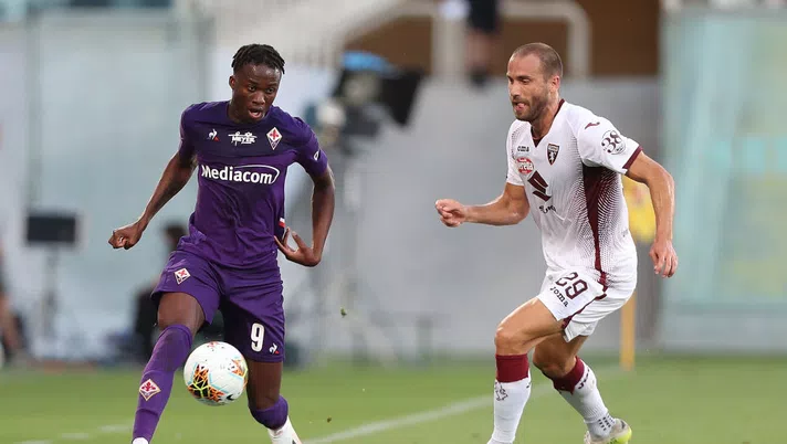 FLORENCE, ITALY - JULY 19: Christian Kouame of ACF Fiorentina battles for the ball with Lorenzo De Silvestri of Torino FC during the Serie A match between ACF Fiorentina and  Torino FC at Stadio Artemio Franchi on July 19, 2020 in Florence, Italy.  (Photo by Gabriele Maltinti/Getty Images)