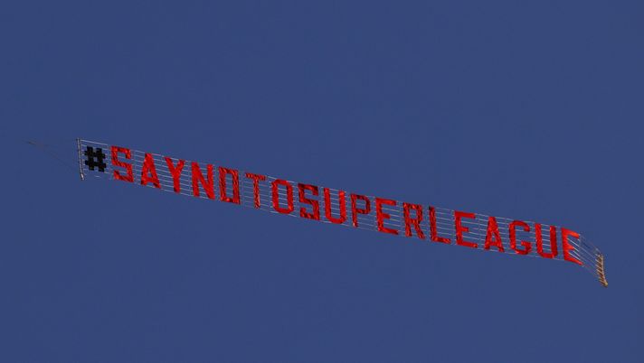 LEEDS, ENGLAND - APRIL 19: A sign is trailed by a plane with a slogan against a proposed new European Super League over the stadium during the warm up for the Premier League match between Leeds United and Liverpool at Elland Road on April 19, 2021 in Leeds, England. Sporting stadiums around the UK remain under strict restrictions due to the Coronavirus Pandemic as Government social distancing laws prohibit fans inside venues resulting in games being played behind closed doors. (Photo by Clive Brunskill/Getty Images) LEEDS, ENGLAND - APRIL 19: A sign is trailed by a plane with a slogan against a proposed new European Super League over the stadium during the warm up for the Premier League match between Leeds United and Liverpool at Elland Road on April 19, 2021 in Leeds, England. Sporting stadiums around the UK remain under strict restrictions due to the Coronavirus Pandemic as Government social distancing laws prohibit fans inside venues resulting in games being played behind closed doors. (Photo by Clive Brunskill/Getty Images)
