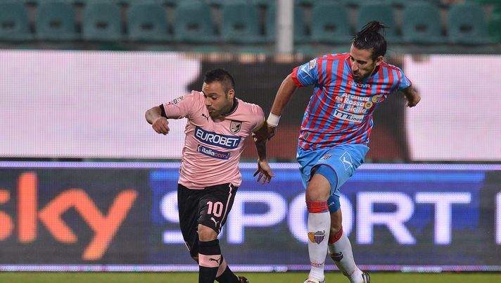 PALERMO, ITALY - NOVEMBER 24:  Fabrizio Miccoli (L) of Palermo and Nicolas Spolli of Catania compete for the ball during the Serie A match between US Citta di Palermo and Calcio Catania at Stadio Renzo Barbera on November 24, 2012 in Palermo, Italy.  (Photo by Tullio M. Puglia/Getty Images) 