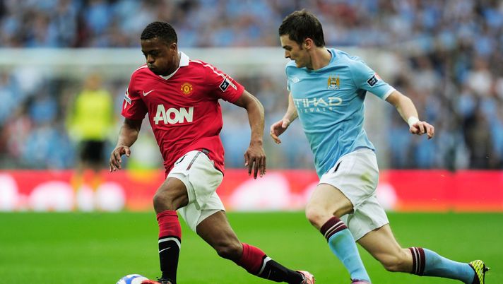 LONDON, ENGLAND - APRIL 16: Adam Johnson of Manchester City chases down Patrice Evra of Manchester United during the FA Cup sponsored by E.ON semi final match between Manchester City and Manchester United at Wembley Stadium on April 16, 2011 in London, England. (Photo by Jamie McDonald/Getty Images) LONDON, ENGLAND - APRIL 16: Adam Johnson of Manchester City chases down Patrice Evra of Manchester United during the FA Cup sponsored by E.ON semi final match between Manchester City and Manchester United at Wembley Stadium on April 16, 2011 in London, England. (Photo by Jamie McDonald/Getty Images)