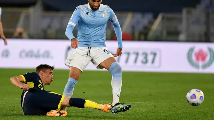 ROME, ITALY - MAY 12: Mohamed Fares of SS Lazio competes for the ball with Maxime Busi of Parma Calcio during the Serie A match between SS Lazio and Parma Calcio at Stadio Olimpico on May 12, 2021 in Rome, Italy. Sporting stadiums around Italy remain under strict restrictions due to the Coronavirus Pandemic as Government social distancing laws prohibit fans inside venues resulting in games being played behind closed doors. (Photo by Marco Rosi - SS Lazio/Getty Images)