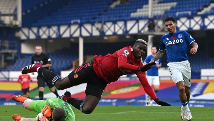 LIVERPOOL, ENGLAND - NOVEMBER 07: Jordan Pickford of Everton collects the ball from the feet of Paul Pogba of Manchester United during the Premier League match between Everton and Manchester United at Goodison Park on November 07, 2020 in Liverpool, England. Sporting stadiums around the UK remain under strict restrictions due to the Coronavirus Pandemic as Government social distancing laws prohibit fans inside venues resulting in games being played behind closed doors. (Photo by Paul Ellis - Pool/Getty Images) LIVERPOOL, ENGLAND - NOVEMBER 07: Jordan Pickford of Everton collects the ball from the feet of Paul Pogba of Manchester United during the Premier League match between Everton and Manchester United at Goodison Park on November 07, 2020 in Liverpool, England. Sporting stadiums around the UK remain under strict restrictions due to the Coronavirus Pandemic as Government social distancing laws prohibit fans inside venues resulting in games being played behind closed doors. (Photo by Paul Ellis - Pool/Getty Images)