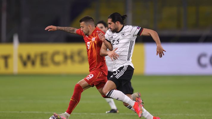 DUISBURG, GERMANY - MARCH 31: Aleksandar Trajkovski of North Macedonia and Emre Can of Germany battle for possession during the FIFA World Cup 2022 Qatar qualifying match between Germany and North Macedonia at Schauinsland-Reisen-Arena on March 31, 2021 in Duisburg, Germany. Sporting stadiums around Germany remain under strict restrictions due to the Coronavirus Pandemic as Government social distancing laws prohibit fans inside venues resulting in games being played behind closed doors. (Photo by Alex Grimm/Getty Images) DUISBURG, GERMANY - MARCH 31: Aleksandar Trajkovski of North Macedonia and Emre Can of Germany battle for possession during the FIFA World Cup 2022 Qatar qualifying match between Germany and North Macedonia at Schauinsland-Reisen-Arena on March 31, 2021 in Duisburg, Germany. Sporting stadiums around Germany remain under strict restrictions due to the Coronavirus Pandemic as Government social distancing laws prohibit fans inside venues resulting in games being played behind closed doors. (Photo by Alex Grimm/Getty Images)