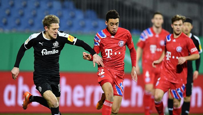 KIEL, GERMANY - JANUARY 13: Johannes van den Bergh of Holstein Kiel battles for possession with Jamal Musiala of Bayern Munich during the DFB Cup second round match between Holstein Kiel and Bayern Muenchen at Wunderino Arena on January 13, 2021 in Kiel, Germany. Sporting stadiums around Germany remain under strict restrictions due to the Coronavirus Pandemic as Government social distancing laws prohibit fans inside venues resulting in games being played behind closed doors. (Photo by Stuart Franklin/Getty Images) KIEL, GERMANY - JANUARY 13: Johannes van den Bergh of Holstein Kiel battles for possession with Jamal Musiala of Bayern Munich during the DFB Cup second round match between Holstein Kiel and Bayern Muenchen at Wunderino Arena on January 13, 2021 in Kiel, Germany. Sporting stadiums around Germany remain under strict restrictions due to the Coronavirus Pandemic as Government social distancing laws prohibit fans inside venues resulting in games being played behind closed doors. (Photo by Stuart Franklin/Getty Images)
