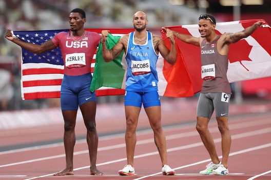 TOKYO, JAPAN - AUGUST 01: Silver medalist Fred Kerley of Team United States, gold medalist Lamont Marcell Jacobs of Team Italy and bronze medalist Andre De Grasse of Team Canada pose on the track following the Men's 100m Final on day nine of the Tokyo 2020 Olympic Games at Olympic Stadium on August 01, 2021 in Tokyo, Japan. (Photo by Patrick Smith/Getty Images) TOKYO, JAPAN - AUGUST 01: Silver medalist Fred Kerley of Team United States, gold medalist Lamont Marcell Jacobs of Team Italy and bronze medalist Andre De Grasse of Team Canada pose on the track following the Men's 100m Final on day nine of the Tokyo 2020 Olympic Games at Olympic Stadium on August 01, 2021 in Tokyo, Japan. (Photo by Patrick Smith/Getty Images)