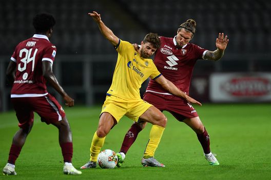  TURIN, ITALY - JULY 22: Vojnovic Lyanco (R) of Torino FC competes with Fabio Borini of Hellas Verona during the Serie A match between Torino FC and Hellas Verona at Stadio Olimpico di Torino on July 22, 2020 in Turin, Italy. (Photo by Valerio Pennicino/Getty Images) 