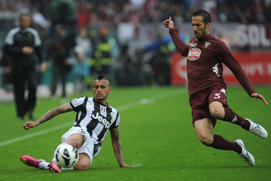 TURIN, ITALY - APRIL 28: Arturo Vidal (L) of Juventus in action against Valerio Di Cesare of Torino FC during the Serie A match between Torino FC and Juventus at Stadio Olimpico di Torino on April 28, 2013 in Turin, Italy. (Photo by Valerio Pennicino/Getty Images) TURIN, ITALY - APRIL 28: Arturo Vidal (L) of Juventus in action against Valerio Di Cesare of Torino FC during the Serie A match between Torino FC and Juventus at Stadio Olimpico di Torino on April 28, 2013 in Turin, Italy. (Photo by Valerio Pennicino/Getty Images)