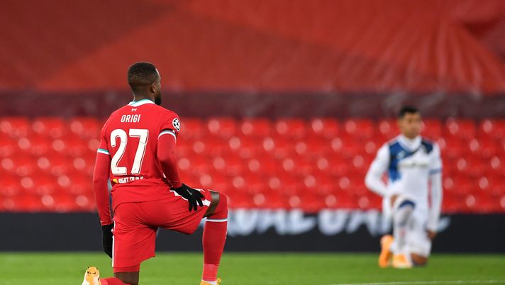 LIVERPOOL, ENGLAND - NOVEMBER 25: Divock Origi of Liverpool takes a knee in support of the Black Lives Matter movement prior to the UEFA Champions League Group D stage match between Liverpool FC and Atalanta BC at Anfield on November 25, 2020 in Liverpool, England. Sporting stadiums around the UK remain under strict restrictions due to the Coronavirus Pandemic as Government social distancing laws prohibit fans inside venues resulting in games being played behind closed doors. (Photo by Paul Ellis - Pool/Getty Images) LIVERPOOL, ENGLAND - NOVEMBER 25: Divock Origi of Liverpool takes a knee in support of the Black Lives Matter movement prior to the UEFA Champions League Group D stage match between Liverpool FC and Atalanta BC at Anfield on November 25, 2020 in Liverpool, England. Sporting stadiums around the UK remain under strict restrictions due to the Coronavirus Pandemic as Government social distancing laws prohibit fans inside venues resulting in games being played behind closed doors. (Photo by Paul Ellis - Pool/Getty Images)