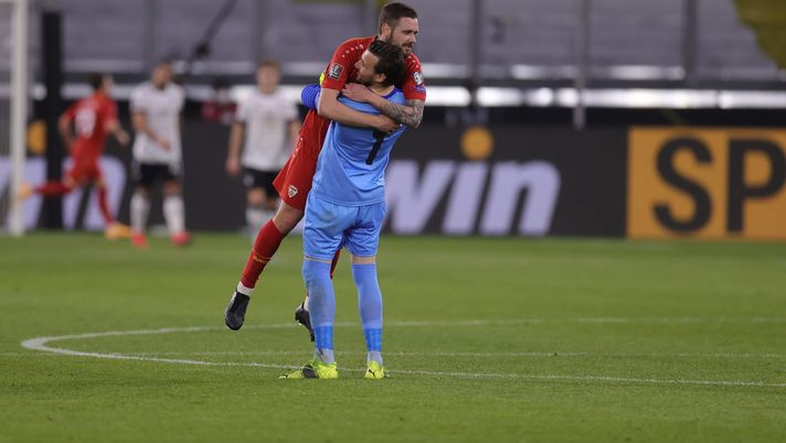 DUISBURG, GERMANY - MARCH 31: Stole Dimitrievski and Darko Velkovski of North Macedonia celebrate their side's second goal during the FIFA World Cup 2022 Qatar qualifying match between Germany and North Macedonia at Schauinsland-Reisen-Arena on March 31, 2021 in Duisburg, Germany. Sporting stadiums around Germany remain under strict restrictions due to the Coronavirus Pandemic as Government social distancing laws prohibit fans inside venues resulting in games being played behind closed doors. (Photo by Alex Grimm/Getty Images) DUISBURG, GERMANY - MARCH 31: Stole Dimitrievski and Darko Velkovski of North Macedonia celebrate their side's second goal during the FIFA World Cup 2022 Qatar qualifying match between Germany and North Macedonia at Schauinsland-Reisen-Arena on March 31, 2021 in Duisburg, Germany. Sporting stadiums around Germany remain under strict restrictions due to the Coronavirus Pandemic as Government social distancing laws prohibit fans inside venues resulting in games being played behind closed doors. (Photo by Alex Grimm/Getty Images)