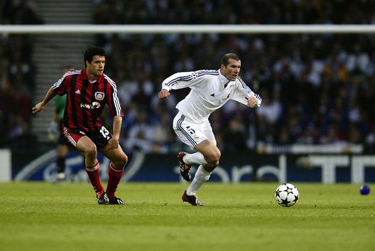 GLASGOW - May 15: Zinedine Zidane of Real Madrid goes past Michael Ballack of Bayer Leverkusen during the UEFA Champions League Final played at Hampden Park, in Glasgow, Scotland on May 15, 2002. Real Madrid won the match and cup 2-1. DIGITAL IMAGE. (Photo by Phil Cole/Getty Images)