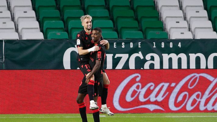 SEVILLE, SPAIN - OCTOBER 18: Adnan Januzaj of Real Sociedad celebrates with teammate Alexander Isak of Real Sociedad after scoring his team's third goal during the La Liga Santander match between Real Betis and Real Sociedad at Estadio Benito Villamarin on October 18, 2020 in Seville, Spain. Sporting stadiums around Spain remain under strict restrictions due to the Coronavirus Pandemic as Government social distancing laws prohibit fans inside venues resulting in games being played behind closed doors. (Photo by Fran Santiago/Getty Images) SEVILLE, SPAIN - OCTOBER 18: Adnan Januzaj of Real Sociedad celebrates with teammate Alexander Isak of Real Sociedad after scoring his team's third goal during the La Liga Santander match between Real Betis and Real Sociedad at Estadio Benito Villamarin on October 18, 2020 in Seville, Spain. Sporting stadiums around Spain remain under strict restrictions due to the Coronavirus Pandemic as Government social distancing laws prohibit fans inside venues resulting in games being played behind closed doors. (Photo by Fran Santiago/Getty Images)