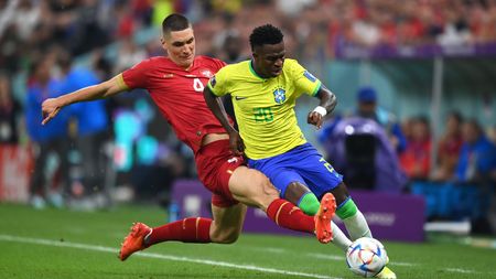 LUSAIL CITY, QATAR - NOVEMBER 24: Vinicius Junior of Brazil battles for possession with Nikola Milenkovic of Serbia during the FIFA World Cup Qatar 2022 Group G match between Brazil and Serbia at Lusail Stadium on November 24, 2022 in Lusail City, Qatar. (Photo by Justin Setterfield/Getty Images)