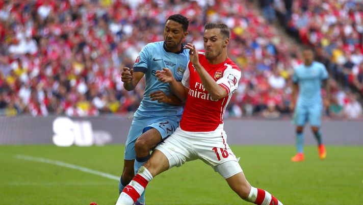 LONDON, ENGLAND - AUGUST 10: Gael Clichy of Manchester City challenges Aaron Ramsey of Arsenal for the all during the FA Community Shield match between Manchester City and Arsenal at Wembley Stadium on August 10, 2014 in London, England.  (Photo by Clive Mason/Getty Images) 