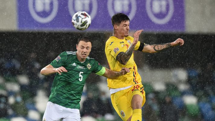 BELFAST, NORTHERN IRELAND - NOVEMBER 18: Jonny Evans of Northern Ireland battles for possession with Dennis Man of Romania during the UEFA Nations League group stage match between Northern Ireland and Romania at Windsor Park on November 18, 2020 in Belfast, Northern Ireland. A limited number of spectators (1060) will be in attendance as Covid-19 pandemic restrictions are eased in Northern Ireland. (Photo by Charles McQuillan/Getty Images) BELFAST, NORTHERN IRELAND - NOVEMBER 18: Jonny Evans of Northern Ireland battles for possession with Dennis Man of Romania during the UEFA Nations League group stage match between Northern Ireland and Romania at Windsor Park on November 18, 2020 in Belfast, Northern Ireland. A limited number of spectators (1060) will be in attendance as Covid-19 pandemic restrictions are eased in Northern Ireland. (Photo by Charles McQuillan/Getty Images)