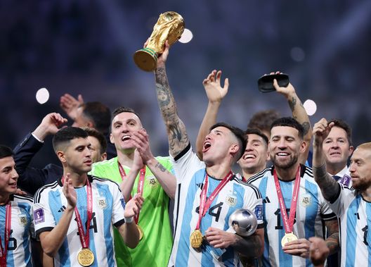 LUSAIL CITY, QATAR - DECEMBER 18: Enzo Fernandez of Argentina lifts the FIFA World Cup Qatar 2022 Winner's Trophy during the FIFA World Cup Qatar 2022 Final match between Argentina and France at Lusail Stadium on December 18, 2022 in Lusail City, Qatar. (Photo by Julian Finney/Getty Images) Enzo Fernandez
