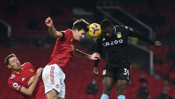 MANCHESTER, ENGLAND - JANUARY 01: Harry Maguire of Manchester United heads the ball under pressure from Keinan Davis of Aston Villa during the Premier League match between Manchester United and Aston Villa at Old Trafford on January 01, 2021 in Manchester, England. (Photo by Laurence Griffiths/Getty Images) MANCHESTER, ENGLAND - JANUARY 01: Harry Maguire of Manchester United heads the ball under pressure from Keinan Davis of Aston Villa during the Premier League match between Manchester United and Aston Villa at Old Trafford on January 01, 2021 in Manchester, England. (Photo by Laurence Griffiths/Getty Images)