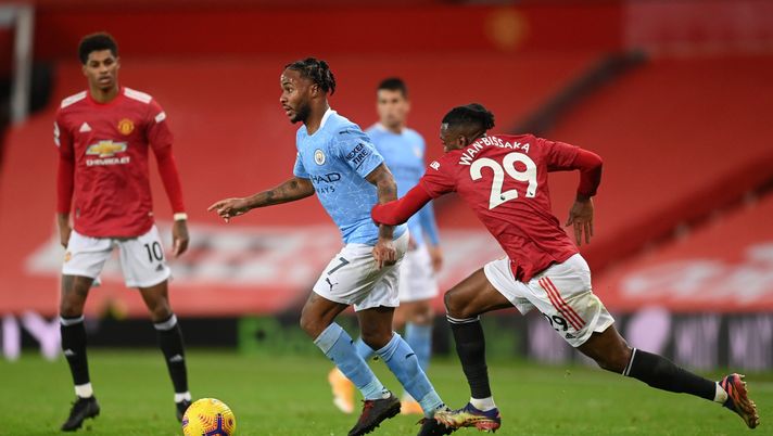 MANCHESTER, ENGLAND - DECEMBER 12: Raheem Sterling of Manchester City is put under pressure by Aaron Wan-Bissaka of Manchester United during the Premier League match between Manchester United and Manchester City at Old Trafford on December 12, 2020 in Manchester, England. The match will be played without fans, behind closed doors as a Covid-19 precaution. (Photo by Michael Regan/Getty Images) MANCHESTER, ENGLAND - DECEMBER 12: Raheem Sterling of Manchester City is put under pressure by Aaron Wan-Bissaka of Manchester United during the Premier League match between Manchester United and Manchester City at Old Trafford on December 12, 2020 in Manchester, England. The match will be played without fans, behind closed doors as a Covid-19 precaution. (Photo by Michael Regan/Getty Images)