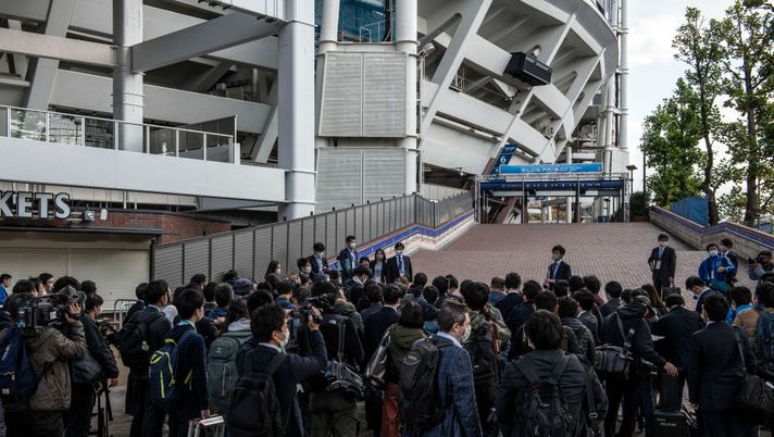 YOKOHAMA, JAPAN - OCTOBER 30: Members of the media gather outside Yokohama Stadium ahead of a baseball match between Yokohama DeNA Baystars and Hanshin Tigers that is being used as a test event to check measures for preventing the spread of Covid-19 coronavirus at big events, on October 30, 2020 in Yokohama, Kanagawa, Japan. The test, which is being overseen by the Japanese government to assess measures for preventing the spread of Covid-19 coronavirus at large events, will use high-precision cameras and beacons to look into the movement and density of spectators in different areas of the stadium as well as the percentage of people wearing face masks. The trial will see 27,000 visitors attend matches over three days in the 34,000-capacity venue and is expected to play a role in deciding how to monitor and control crowds during the postponed Tokyo Olympics. (Photo by Carl Court/Getty Images) YOKOHAMA, JAPAN - OCTOBER 30: Members of the media gather outside Yokohama Stadium ahead of a baseball match between Yokohama DeNA Baystars and Hanshin Tigers that is being used as a test event to check measures for preventing the spread of Covid-19 coronavirus at big events, on October 30, 2020 in Yokohama, Kanagawa, Japan. The test, which is being overseen by the Japanese government to assess measures for preventing the spread of Covid-19 coronavirus at large events, will use high-precision cameras and beacons to look into the movement and density of spectators in different areas of the stadium as well as the percentage of people wearing face masks. The trial will see 27,000 visitors attend matches over three days in the 34,000-capacity venue and is expected to play a role in deciding how to monitor and control crowds during the postponed Tokyo Olympics. (Photo by Carl Court/Getty Images)