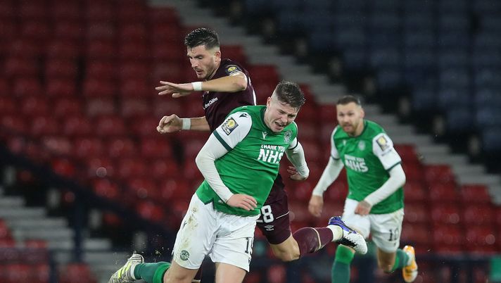GLASGOW, SCOTLAND - OCTOBER 31: Kevin Nisbet of Hibernian FC is challenged by Mihai Popescu of Heart of Midlothian during the William Hill Scottish Cup first semi-final match between Heart of Midlothian and Hibernian at Hampden Park National Stadium on October 31, 2020 in Glasgow, Scotland. Sporting stadiums around the UK remain under strict restrictions due to the Coronavirus Pandemic as Government social distancing laws prohibit fans inside venues resulting in games being played behind closed doors. (Photo by Ian MacNicol/Getty Images) GLASGOW, SCOTLAND - OCTOBER 31: Kevin Nisbet of Hibernian FC is challenged by Mihai Popescu of Heart of Midlothian during the William Hill Scottish Cup first semi-final match between Heart of Midlothian and Hibernian at Hampden Park National Stadium on October 31, 2020 in Glasgow, Scotland. Sporting stadiums around the UK remain under strict restrictions due to the Coronavirus Pandemic as Government social distancing laws prohibit fans inside venues resulting in games being played behind closed doors. (Photo by Ian MacNicol/Getty Images)