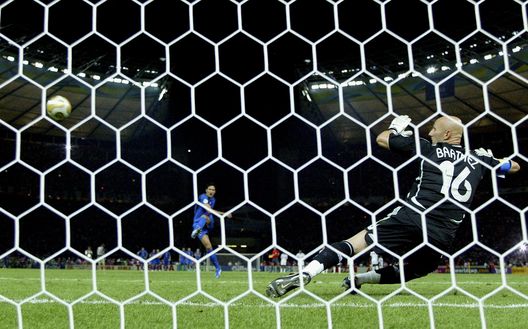 BERLIN - JULY 09: Fabio Grosso (L) of Italy takes the matchwinning penalty, as Goalkeeper Fabien Barthez (R) of France dives the wrong way during the FIFA World Cup Germany 2006 Final match between Italy and France at the Olympic Stadium on July 9, 2006 in Berlin, Germany. (Photo by Michael Steele/Getty Images) BERLIN - JULY 09: Fabio Grosso (L) of Italy takes the matchwinning penalty, as Goalkeeper Fabien Barthez (R) of France dives the wrong way during the FIFA World Cup Germany 2006 Final match between Italy and France at the Olympic Stadium on July 9, 2006 in Berlin, Germany. (Photo by Michael Steele/Getty Images)
