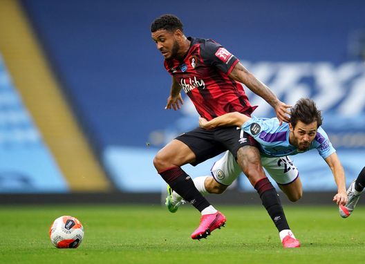  MANCHESTER, ENGLAND - JULY 15: Bernardo Silva of Manchester City is challenged by Joshua King of AFC Bournemouth during the Premier League match between Manchester City and AFC Bournemouth at Etihad Stadium on July 15, 2020 in Manchester, England. Football Stadiums around Europe remain empty due to the Coronavirus Pandemic as Government social distancing laws prohibit fans inside venues resulting in all fixtures being played behind closed doors. (Photo by Dave Thompson/Pool via Getty Images) 