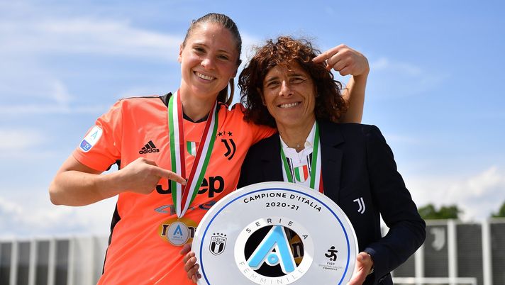 VINOVO, ITALY - MAY 23: Laura Giuliani of Juventus and Juventus head coach Rita Guarino celebrate with the trophy after the Women Serie A match between Juventus and FC Internazionale at Juventus Center Vinovo on May 23, 2021 in Vinovo, Italy. (Photo by Valerio Pennicino - Juventus FC/Juventus FC via Getty Images) VINOVO, ITALY - MAY 23: Laura Giuliani of Juventus and Juventus head coach Rita Guarino celebrate with the trophy after the Women Serie A match between Juventus and FC Internazionale at Juventus Center Vinovo on May 23, 2021 in Vinovo, Italy. (Photo by Valerio Pennicino - Juventus FC/Juventus FC via Getty Images)