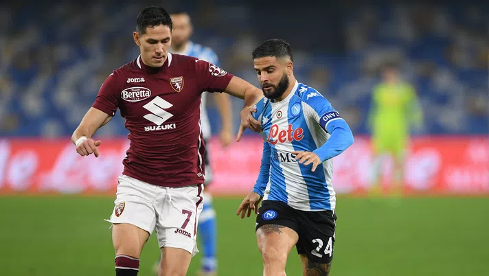 NAPLES, ITALY - DECEMBER 23: Lorenzo Insigne of SSC Napoli battles for possession with Sasa Lukic of Torino during the Serie A match between SSC Napoli and Torino FC at Stadio Diego Armando Maradona on December 23, 2020 in Naples, Italy. Sporting stadiums around Italy remain under strict restrictions due to the Coronavirus Pandemic as Government social distancing laws prohibit fans inside venues resulting in games being played behind closed doors. (Photo by Francesco Pecoraro/Getty Images)