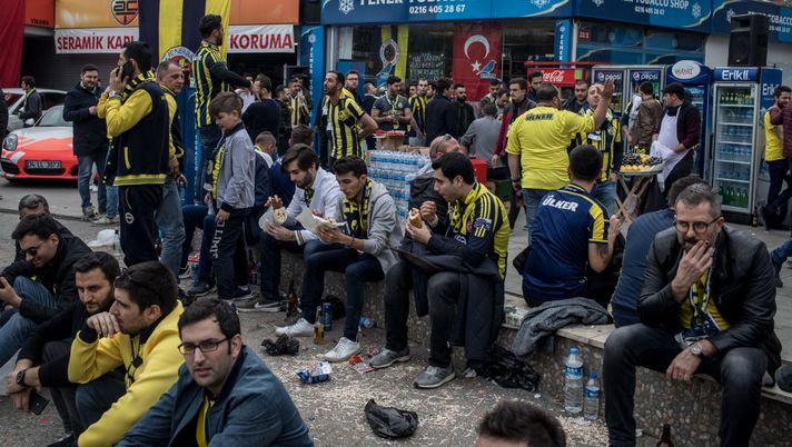 ISTANBUL, TURKEY - MARCH 17: Fenerbahce supporters eat and drink outside Fenerbahce Stadium ahead of the start of the Istanbul Derby match between Fenerbahce and Galatasaray on March 17, 2018 in Istanbul, Turkey. The Istanbul Derby also known as the Intercontinental Derby is one of footballs fiercest rivalries. Turkey's football fans are some of the most passionate in the world. Fans are forced to travel and enter the stadium separately, with Galatasaray supporters taken to the game on a convoy of buses accompanied by a police escort arriving to a scene of hundreds of riot police standing guard to keep fans seperated. The derby was first played in 1909 and and has often been marred by acts of hooliganism and heavy violence. In 2013 the violence peaked with the stabbing of a 19-year-old Fenerbahce fan after the match. In recent years the efforts of police and fans alike have helped to keep the matches relatively violence free. (Photo by Chris McGrath/Getty Images) ISTANBUL, TURKEY - MARCH 17: Fenerbahce supporters eat and drink outside Fenerbahce Stadium ahead of the start of the Istanbul Derby match between Fenerbahce and Galatasaray on March 17, 2018 in Istanbul, Turkey. The Istanbul Derby also known as the Intercontinental Derby is one of footballs fiercest rivalries. Turkey's football fans are some of the most passionate in the world. Fans are forced to travel and enter the stadium separately, with Galatasaray supporters taken to the game on a convoy of buses accompanied by a police escort arriving to a scene of hundreds of riot police standing guard to keep fans seperated. The derby was first played in 1909 and and has often been marred by acts of hooliganism and heavy violence. In 2013 the violence peaked with the stabbing of a 19-year-old Fenerbahce fan after the match. In recent years the efforts of police and fans alike have helped to keep the matches relatively violence free. (Photo by Chris McGrath/Getty Images)