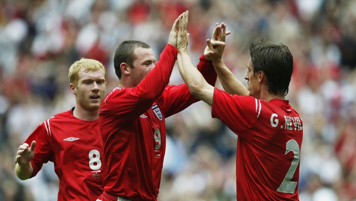 MANCHESTER, ENGLAND - JUNE 5:  Wayne Rooney (C) of England celebrates his goal with Gary Neville during the FA Summer Tournament match between England and Iceland at the City of Manchester Stadium on June 5, 2004 in Manchester, England. (Photo by Alex Livesey/Getty Images) 