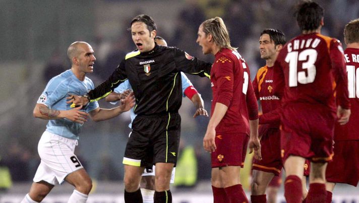 ROME, ITALY - FEBRUARY 26: Match referee Matteo Trefoloni seperates Paolo Di Canio of Lazio and Philippe Mexes of Roma during the Serie A match between Lazio and Roma at the Stadio Olimpico on February 26, 2006 in Roma, Italy. (Photo by New Press/Getty Images) ROME, ITALY - FEBRUARY 26: Match referee Matteo Trefoloni seperates Paolo Di Canio of Lazio and Philippe Mexes of Roma during the Serie A match between Lazio and Roma at the Stadio Olimpico on February 26, 2006 in Roma, Italy. (Photo by New Press/Getty Images)