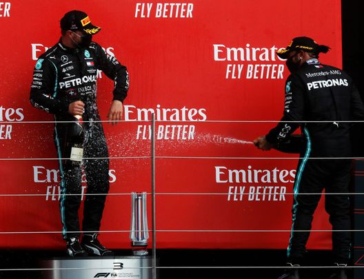 NORTHAMPTON, ENGLAND - AUGUST 09: Second placed Lewis Hamilton of Great Britain and Mercedes GP and third placed Valtteri Bottas of Finland and Mercedes GP celebrate on the podium during the F1 70th Anniversary Grand Prix at Silverstone on August 09, 2020 in Northampton, England. (Photo by Frank Augstein/Pool via Getty Images) NORTHAMPTON, ENGLAND - AUGUST 09: Second placed Lewis Hamilton of Great Britain and Mercedes GP and third placed Valtteri Bottas of Finland and Mercedes GP celebrate on the podium during the F1 70th Anniversary Grand Prix at Silverstone on August 09, 2020 in Northampton, England. (Photo by Frank Augstein/Pool via Getty Images)