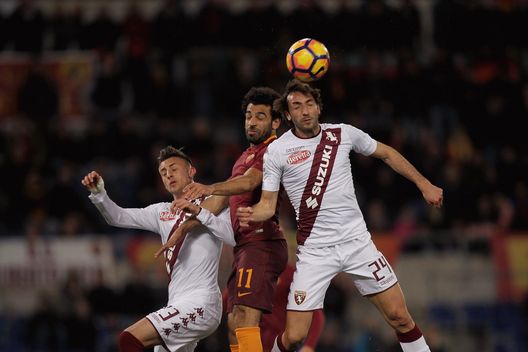  ROME, ITALY - FEBRUARY 19: Mohamed Salah of AS Roma competes for the ball with Emiliano Moretti #24 and Antonio Barreca of FC Torino during the Serie A match between AS Roma and FC Torino at Stadio Olimpico on February 19, 2017 in Rome, Italy. (Photo by Paolo Bruno/Getty Images) 