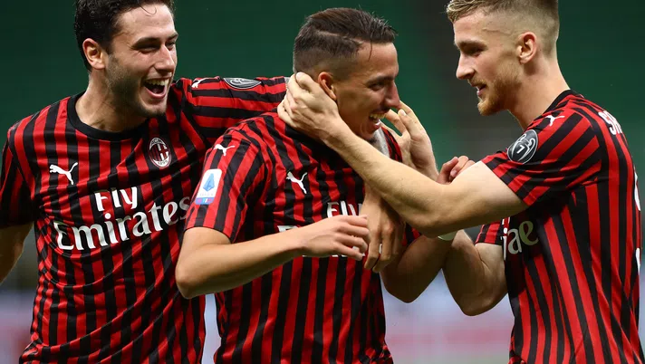 MILAN, ITALY - JULY 18:  Ismael Bennacer (C) of AC Milan celebrates his goal with his team-mates Alexis Saelemaekers (R) and Davide Calabria (L) during the Serie A match between AC Milan and Bologna FC at Stadio Giuseppe Meazza on July 18, 2020 in Milan, Italy.  (Photo by Marco Luzzani/Getty Images)