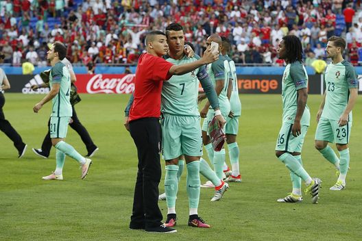 Cristiano Ronaldo of Portugal with fan who makes selfie during the UEFA EURO semi-final match between Portugal and Wales on July 6, 2016 at the Stade de Lyon in Lyon, France.(Photo by VI Images via Getty Images) 
