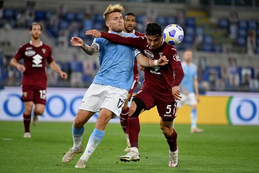  ROME, ITALY - MAY 18: Ciro Immobile of SS Lazio competes for the ball with Armando Izzo of Torino FC during the Serie A match between SS Lazio and Torino FC at Stadio Olimpico on May 18, 2021 in Rome, Italy. (Photo by Marco Rosi - SS Lazio/Getty Images) 