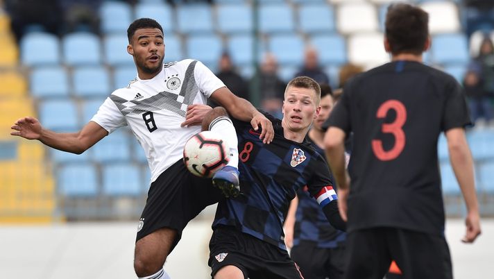 SINJ, CROATIA - MARCH 20: Manuel Mbom (L) of Germany and Ante Palaversa of Croatia compete for the ball during the UEFA Elite Round match between Croatia U19 and Germany U19 at Gradski stadion on March 20, 2019 in Sinj, Croatia. (Photo by Tullio M. Puglia/Getty Images)  Manchester City