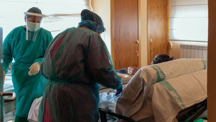 HUESCA, SPAIN - APRIL 16: Two nurses care for a patient infected with coronavirus (Covid-19) at the La Abubilla residence on April 16, 2020 in Yequeda, Huesca, Spain. The La Abubilla nursing home takes in people infected with the coronavirus (Covid-19) to help hospitals saturated with people infected on April 16, 2020. 83 patients have passed through this residence, of which 22 have died and 10 have been cured. There are currently 46 at the residence.(Photo by Alvaro Calvo / Getty Images) HUESCA, SPAIN - APRIL 16: Two nurses care for a patient infected with coronavirus (Covid-19) at the La Abubilla residence on April 16, 2020 in Yequeda, Huesca, Spain. The La Abubilla nursing home takes in people infected with the coronavirus (Covid-19) to help hospitals saturated with people infected on April 16, 2020. 83 patients have passed through this residence, of which 22 have died and 10 have been cured. There are currently 46 at the residence.(Photo by Alvaro Calvo / Getty Images)
