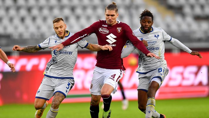 TURIN, ITALY - JANUARY 06: Federico Dimarco of Hellas Verona F.C. and Adrien Tameze of Hellas Verona F.C. battles for possession with Lyanco of Torino F.C. during the Serie A match between Torino FC and Hellas Verona FC at Stadio Olimpico di Torino on January 06, 2021 in Turin, Italy. Sporting stadiums around Italy remain under strict restrictions due to the Coronavirus Pandemic as Government social distancing laws prohibit fans inside venues resulting in games being played behind closed doors. (Photo by Valerio Pennicino/Getty Images) TURIN, ITALY - JANUARY 06: Federico Dimarco of Hellas Verona F.C. and Adrien Tameze of Hellas Verona F.C. battles for possession with Lyanco of Torino F.C. during the Serie A match between Torino FC and Hellas Verona FC at Stadio Olimpico di Torino on January 06, 2021 in Turin, Italy. Sporting stadiums around Italy remain under strict restrictions due to the Coronavirus Pandemic as Government social distancing laws prohibit fans inside venues resulting in games being played behind closed doors. (Photo by Valerio Pennicino/Getty Images)
